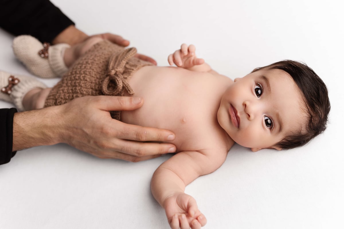Newborn - Brown Shorts Being Held