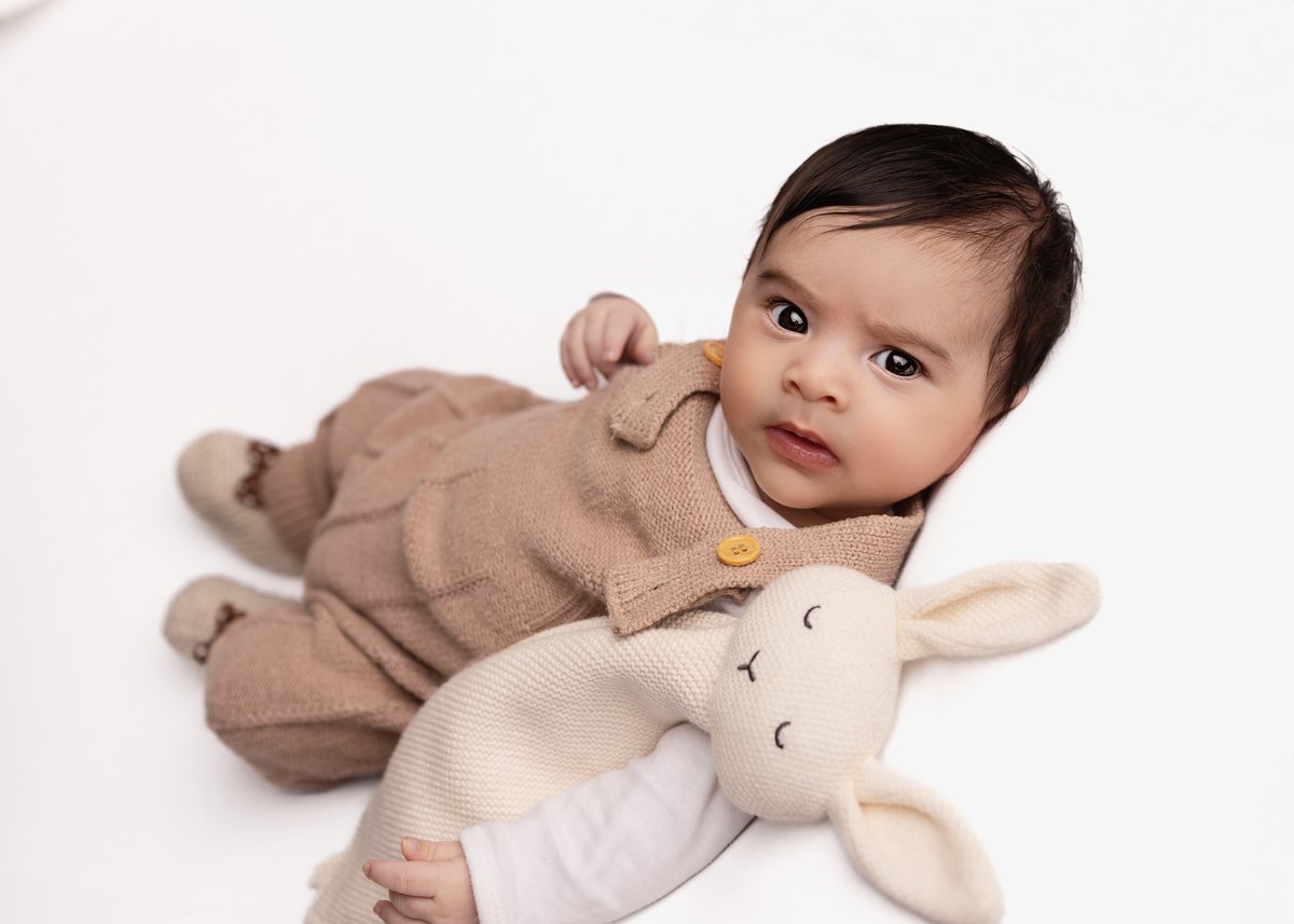 Newborn - brown onesie and white rabbit toy